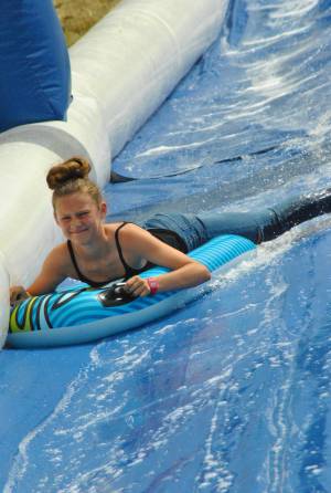 Ilminster Town FC fun day Part 28 – July 9, 2016: A giant water slide was the star attraction at a family fun day held to celebrate Ilminster Town Football Club’s new Archie Gooch Pavilion headquarters in Britten’s Field. Photo 1