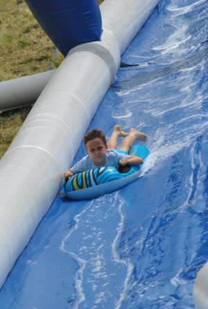 Ilminster Town FC fun day Part 28 – July 9, 2016: A giant water slide was the star attraction at a family fun day held to celebrate Ilminster Town Football Club’s new Archie Gooch Pavilion headquarters in Britten’s Field. Photo 9