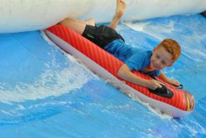 Ilminster Town FC fun day Part 29 – July 9, 2016: A giant water slide was the star attraction at a family fun day held to celebrate Ilminster Town Football Club’s new Archie Gooch Pavilion headquarters in Britten’s Field. Photo 23