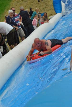 Ilminster Town FC fun day Part 29 – July 9, 2016: A giant water slide was the star attraction at a family fun day held to celebrate Ilminster Town Football Club’s new Archie Gooch Pavilion headquarters in Britten’s Field. Photo 25