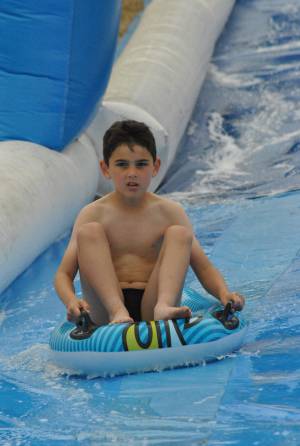 Ilminster Town FC fun day Part 30 – July 9, 2016: A giant water slide was the star attraction at a family fun day held to celebrate Ilminster Town Football Club’s new Archie Gooch Pavilion headquarters in Britten’s Field. Photo 10