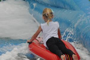 Ilminster Town FC fun day Part 30 – July 9, 2016: A giant water slide was the star attraction at a family fun day held to celebrate Ilminster Town Football Club’s new Archie Gooch Pavilion headquarters in Britten’s Field. Photo 16
