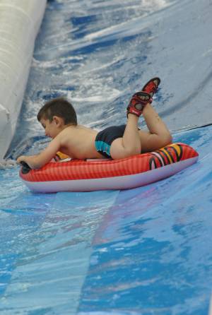 Ilminster Town FC fun day Part 30 – July 9, 2016: A giant water slide was the star attraction at a family fun day held to celebrate Ilminster Town Football Club’s new Archie Gooch Pavilion headquarters in Britten’s Field. Photo 17