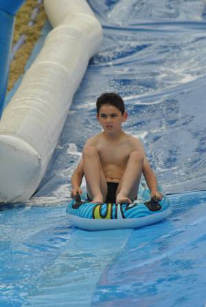 Ilminster Town FC fun day Part 30 – July 9, 2016: A giant water slide was the star attraction at a family fun day held to celebrate Ilminster Town Football Club’s new Archie Gooch Pavilion headquarters in Britten’s Field. Photo 9
