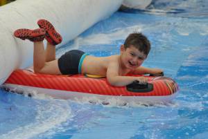 Ilminster Town FC fun day Part 31 – July 9, 2016: A giant water slide was the star attraction at a family fun day held to celebrate Ilminster Town Football Club’s new Archie Gooch Pavilion headquarters in Britten’s Field. Photo 16
