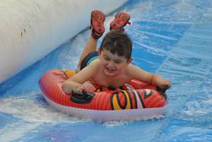Ilminster Town FC fun day Part 31 – July 9, 2016: A giant water slide was the star attraction at a family fun day held to celebrate Ilminster Town Football Club’s new Archie Gooch Pavilion headquarters in Britten’s Field. Photo 17