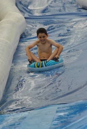 Ilminster Town FC fun day Part 31 – July 9, 2016: A giant water slide was the star attraction at a family fun day held to celebrate Ilminster Town Football Club’s new Archie Gooch Pavilion headquarters in Britten’s Field. Photo 5