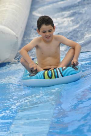 Ilminster Town FC fun day Part 31 – July 9, 2016: A giant water slide was the star attraction at a family fun day held to celebrate Ilminster Town Football Club’s new Archie Gooch Pavilion headquarters in Britten’s Field. Photo 6