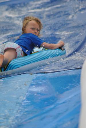Ilminster Town FC fun day Part 35 – July 9, 2016: A giant water slide was the star attraction at a family fun day held to celebrate Ilminster Town Football Club’s new Archie Gooch Pavilion headquarters in Britten’s Field. Photo 26